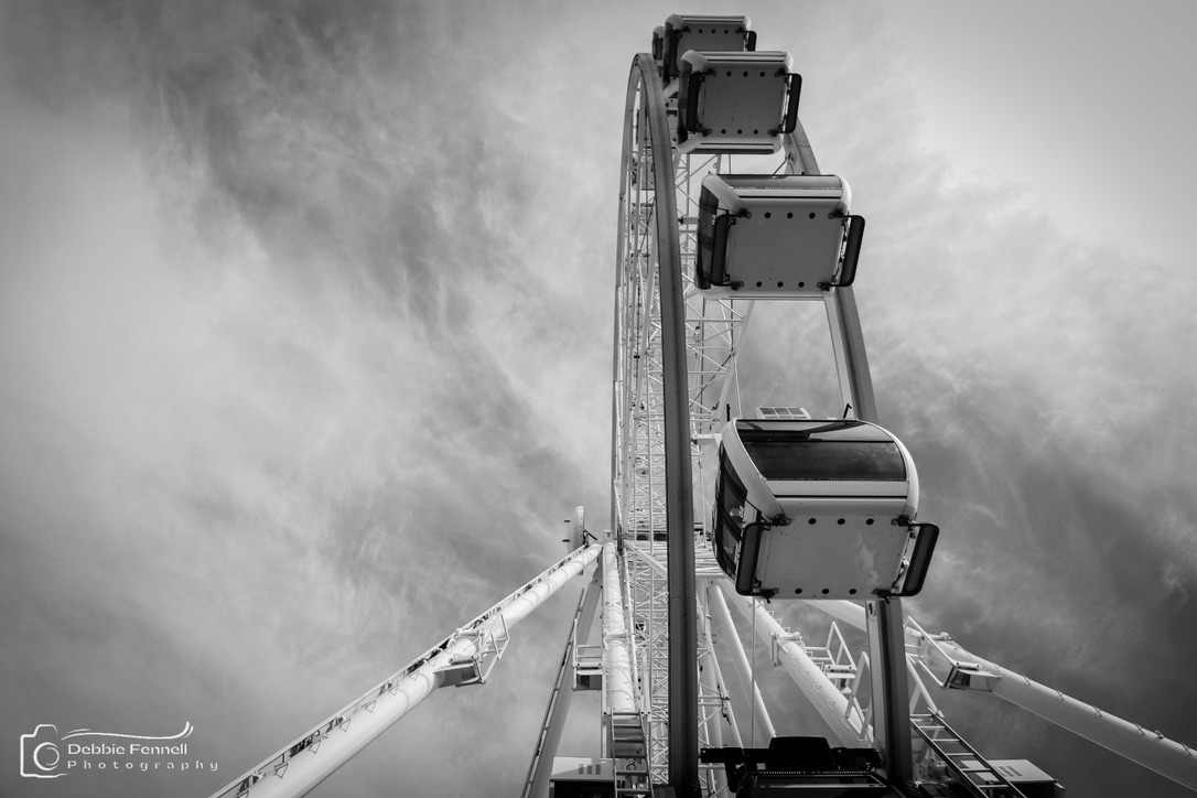 Black-and-white upward view of the Cape Wheel cabins and supporting structure